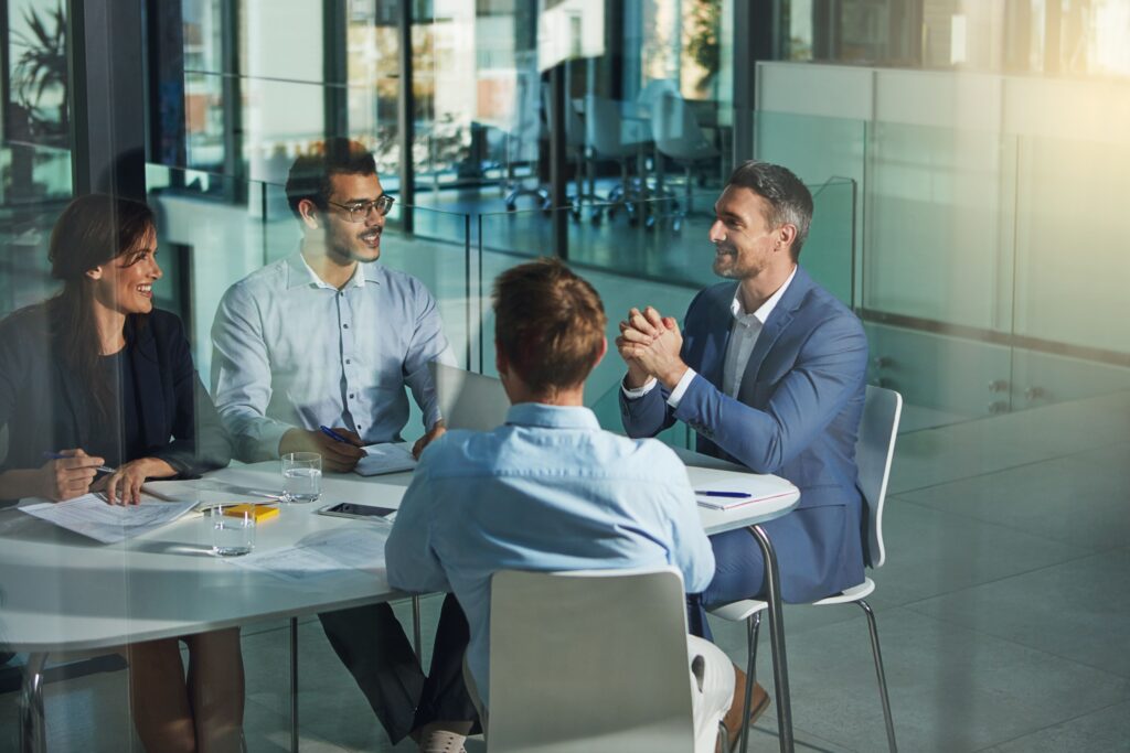 Business people, meeting and discussion for business planning, strategy or brainstorming in the office. Group of employees in a business meeting, team planning or workplace collaboration.
